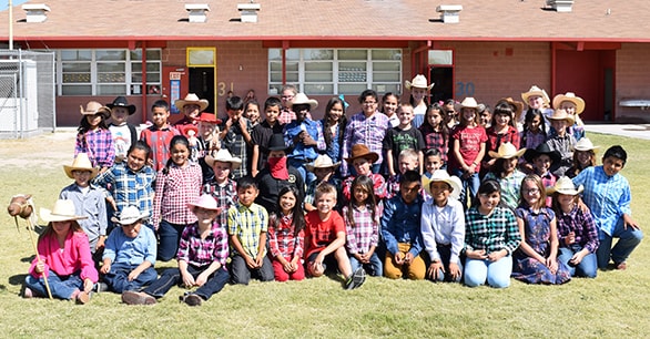 Students outside classroom dressed in western attire